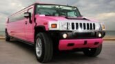 A vibrant pink Hummer H2 limo parked in Milton, ready for a birthday party or special event rental.